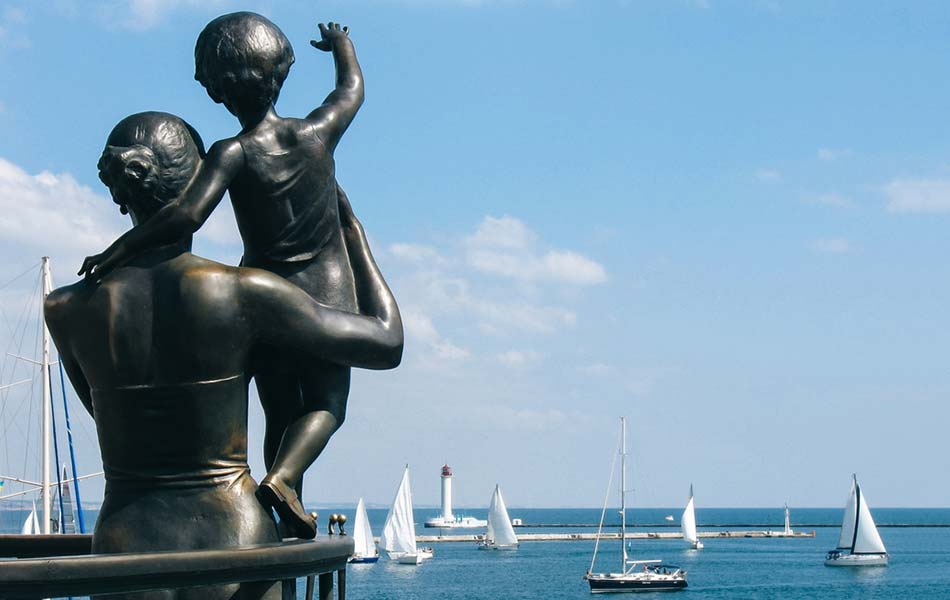 a status at the Odesa Sea Port of a mother holding a child