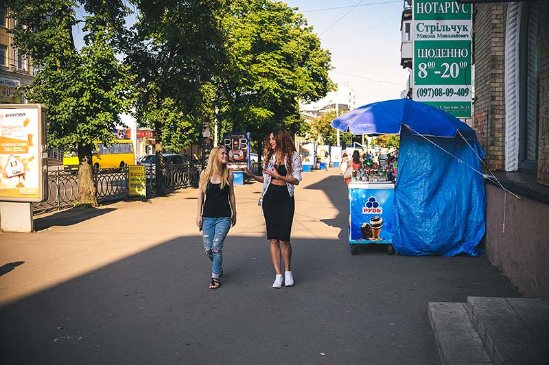 Two young women walking on a street