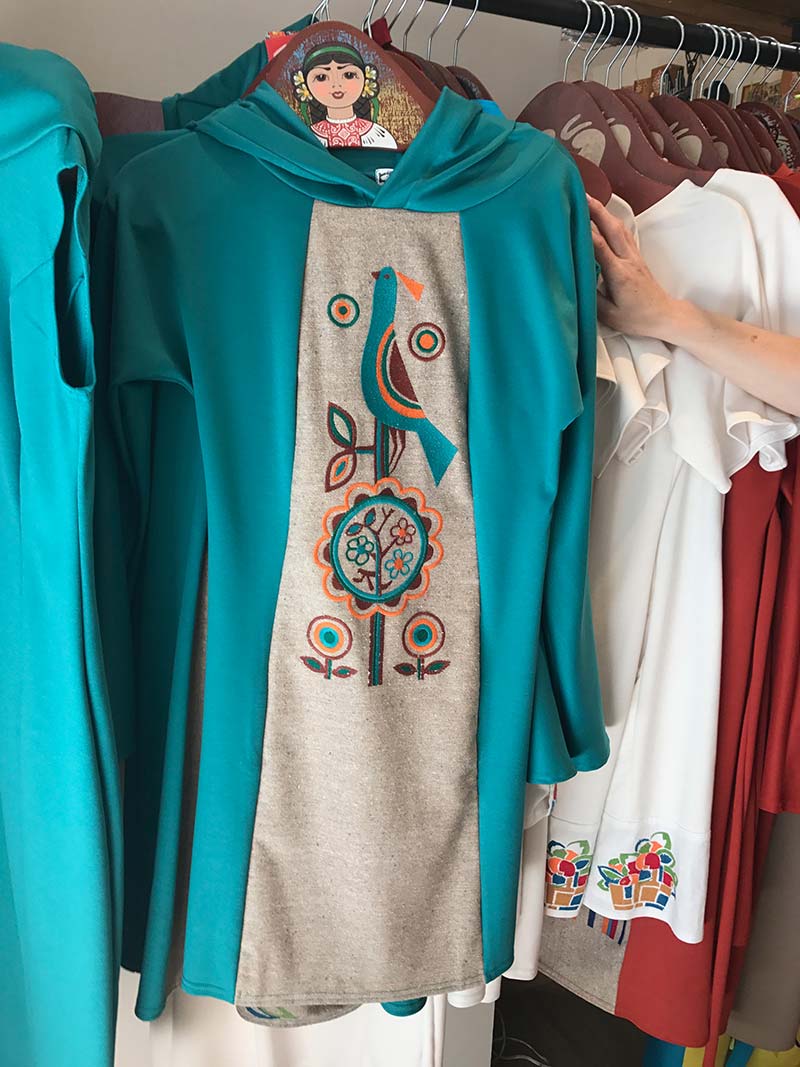 A hoodie with embroidery hanging on a hanger