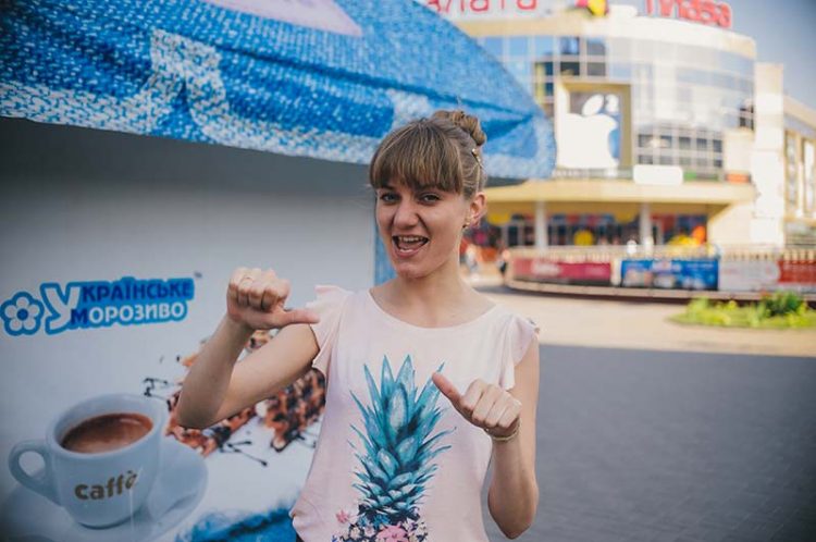 A young woman showing thumbs up